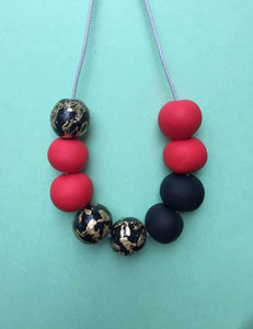 Nine Angels Black, red & gold leaf necklace