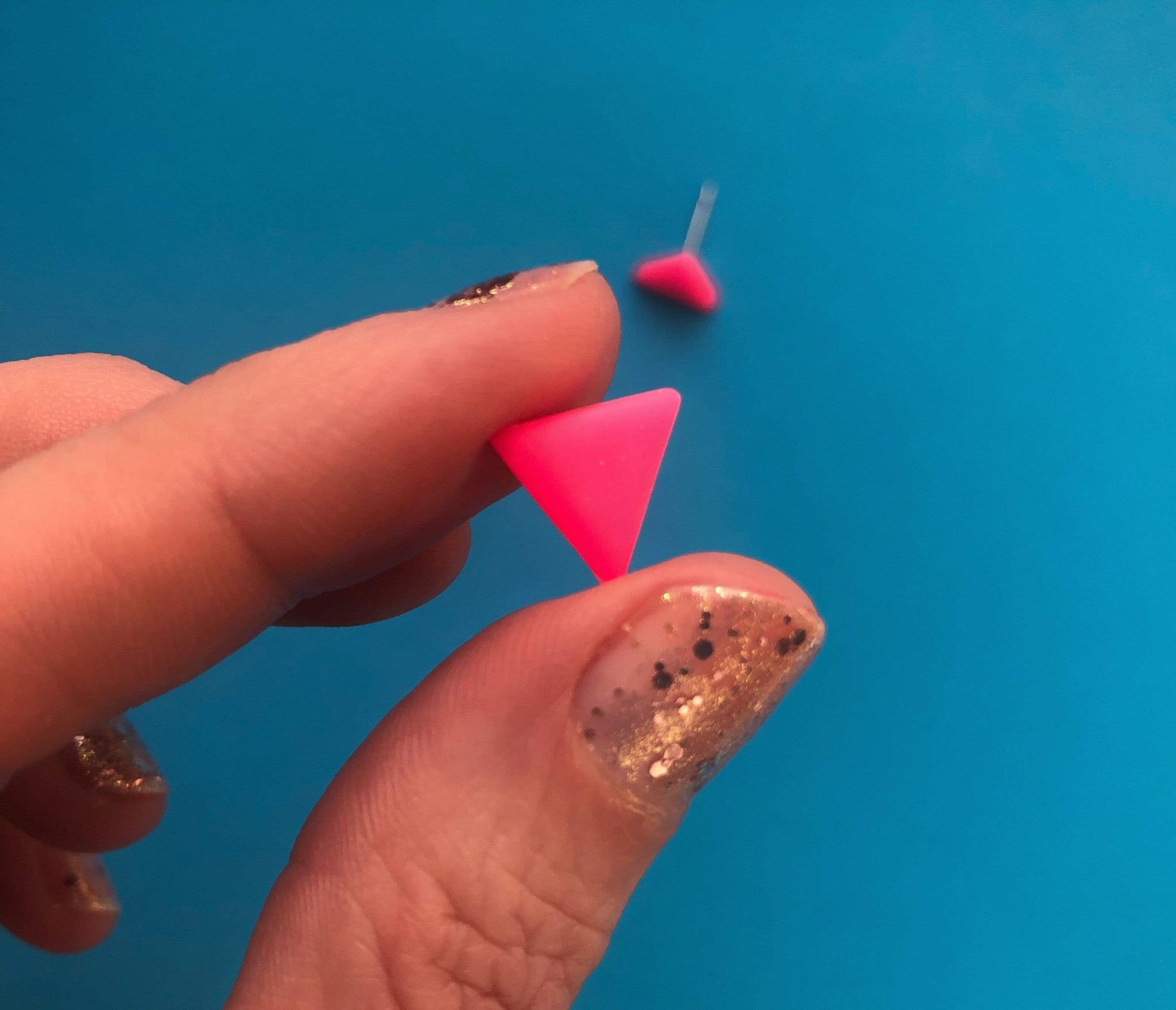 Neon pink triangle earrings Nine Angels