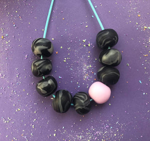 Nine Angels Pale pink & black clay bead necklace